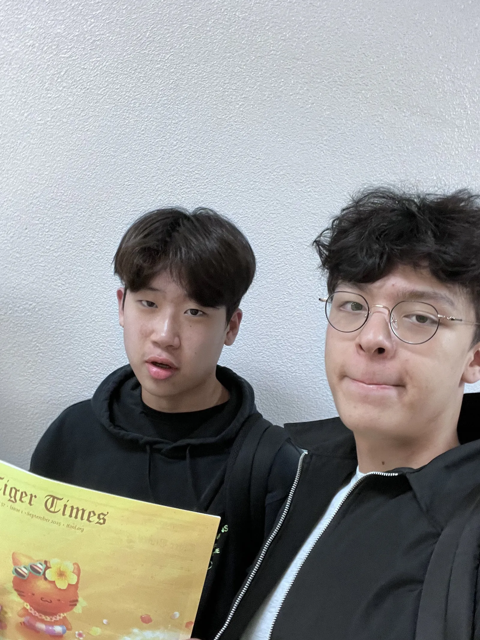 Anders in glasses and another student holding a copy of Tiger Times, Issue 1, September 2025